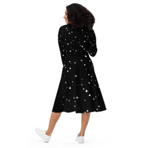 A woman in black dress walking on the ground.
