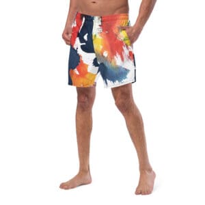 A man wearing swim trunks with flowers on it.