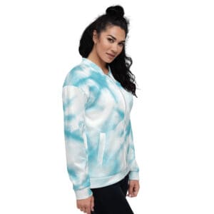 A woman standing in front of a wall with a blue cloud pattern.