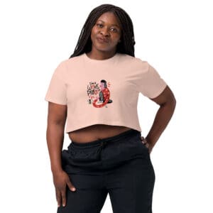 A woman wearing a pink crop top and black pants.