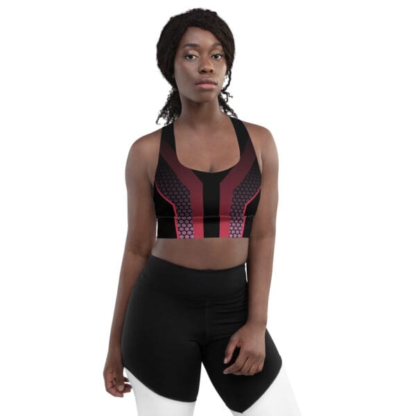 A woman in black and red sports bra standing next to a white wall.