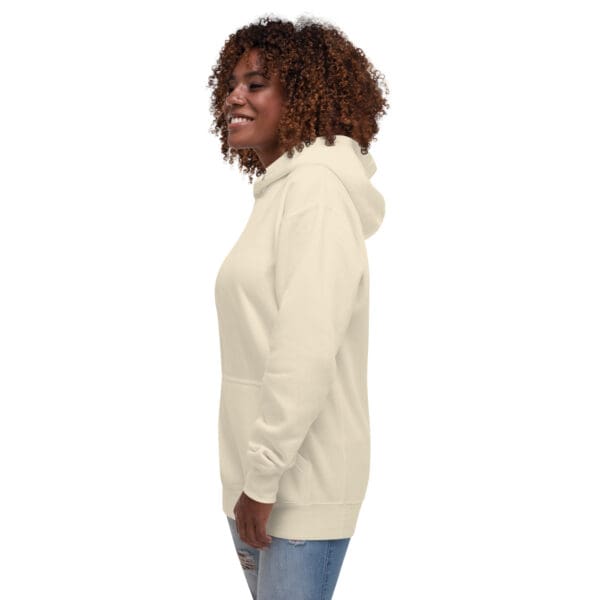 A woman wearing jeans and a white hoodie.