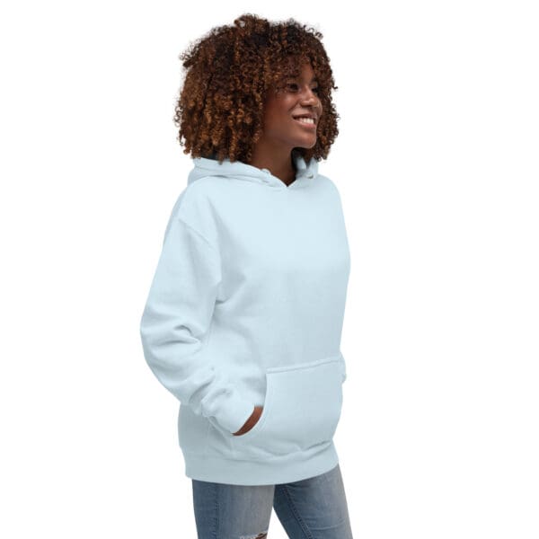 A woman in white hoodie with her hands in pockets.