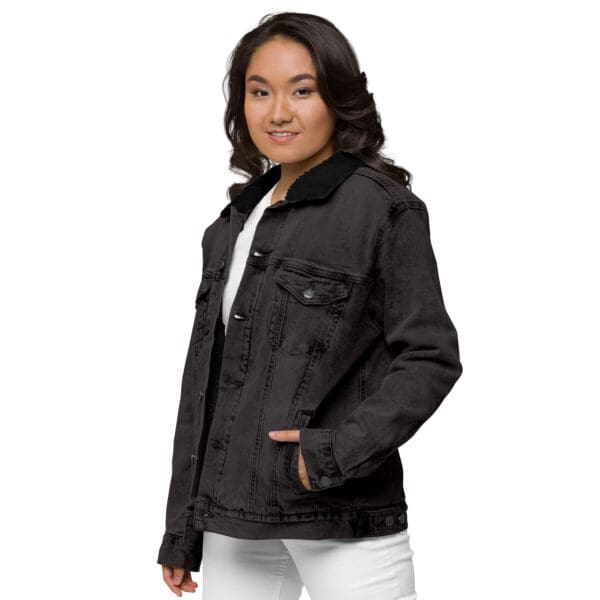 A woman wearing a black jacket and white pants.